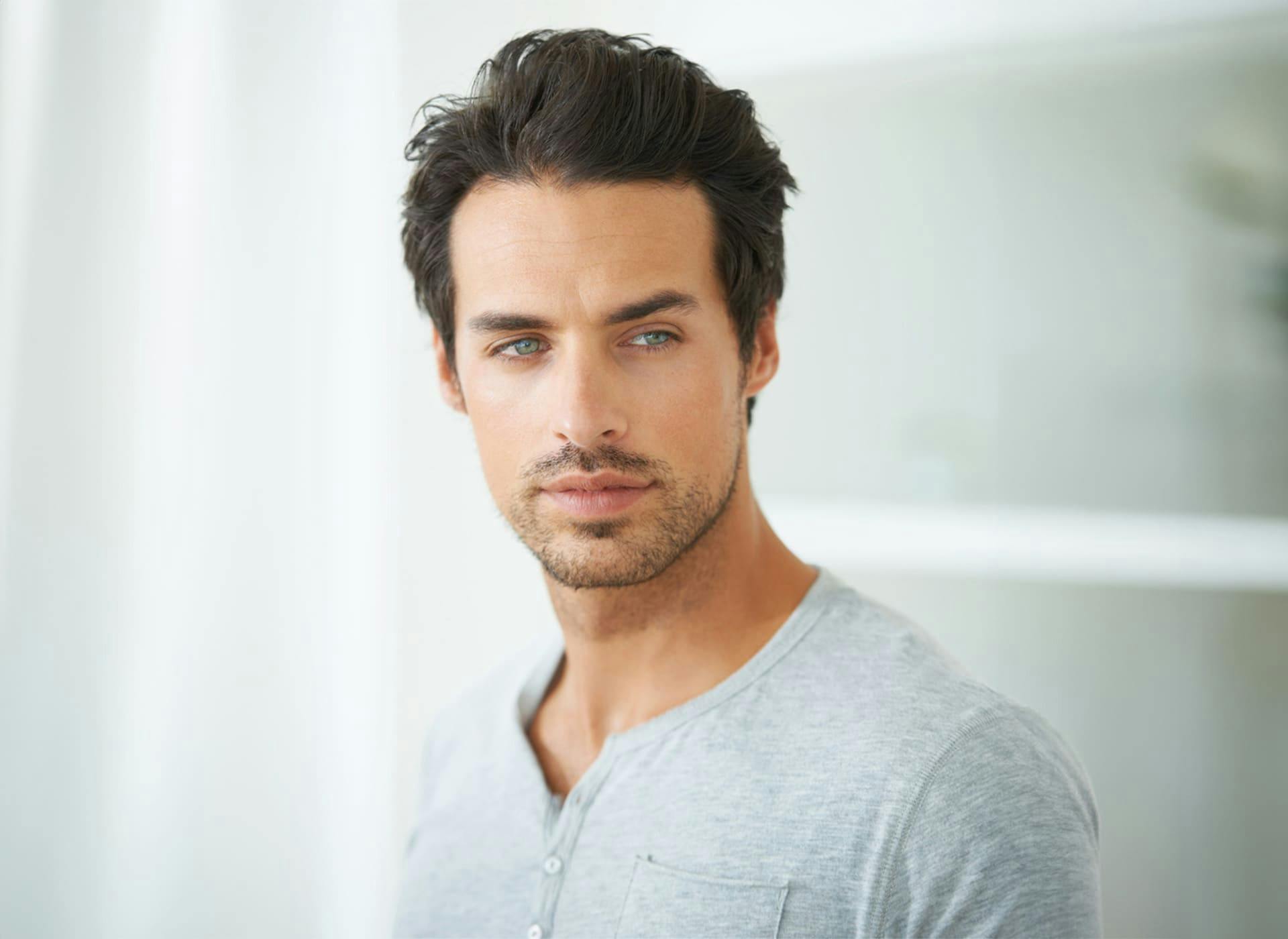 man in gray shirt looking forward