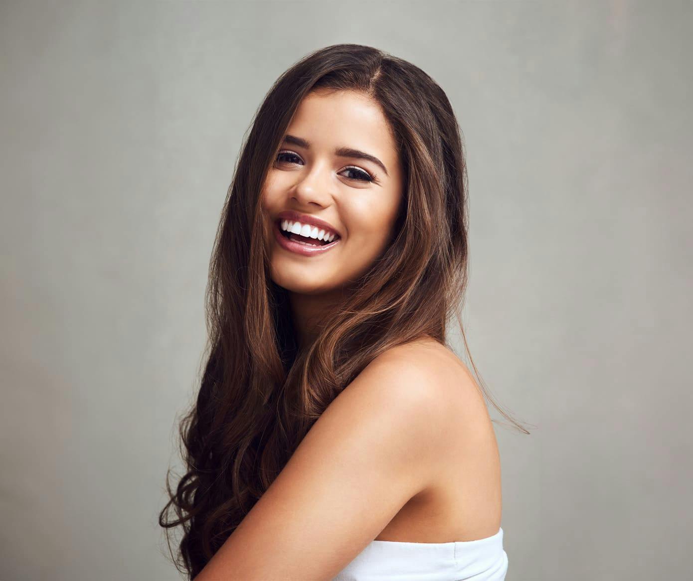 woman smiling with long brunette hair