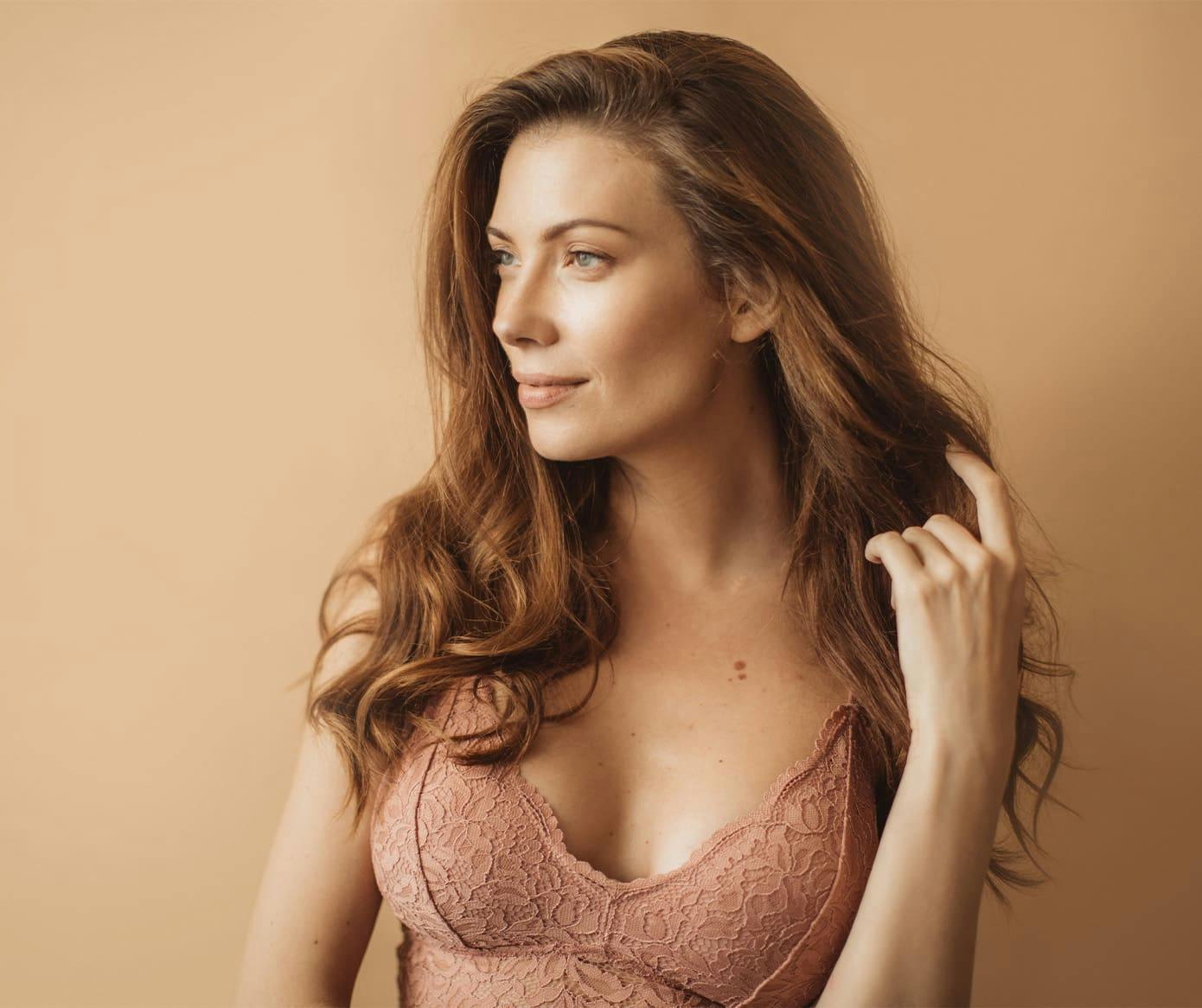 woman looking to the left in pinkish bra on