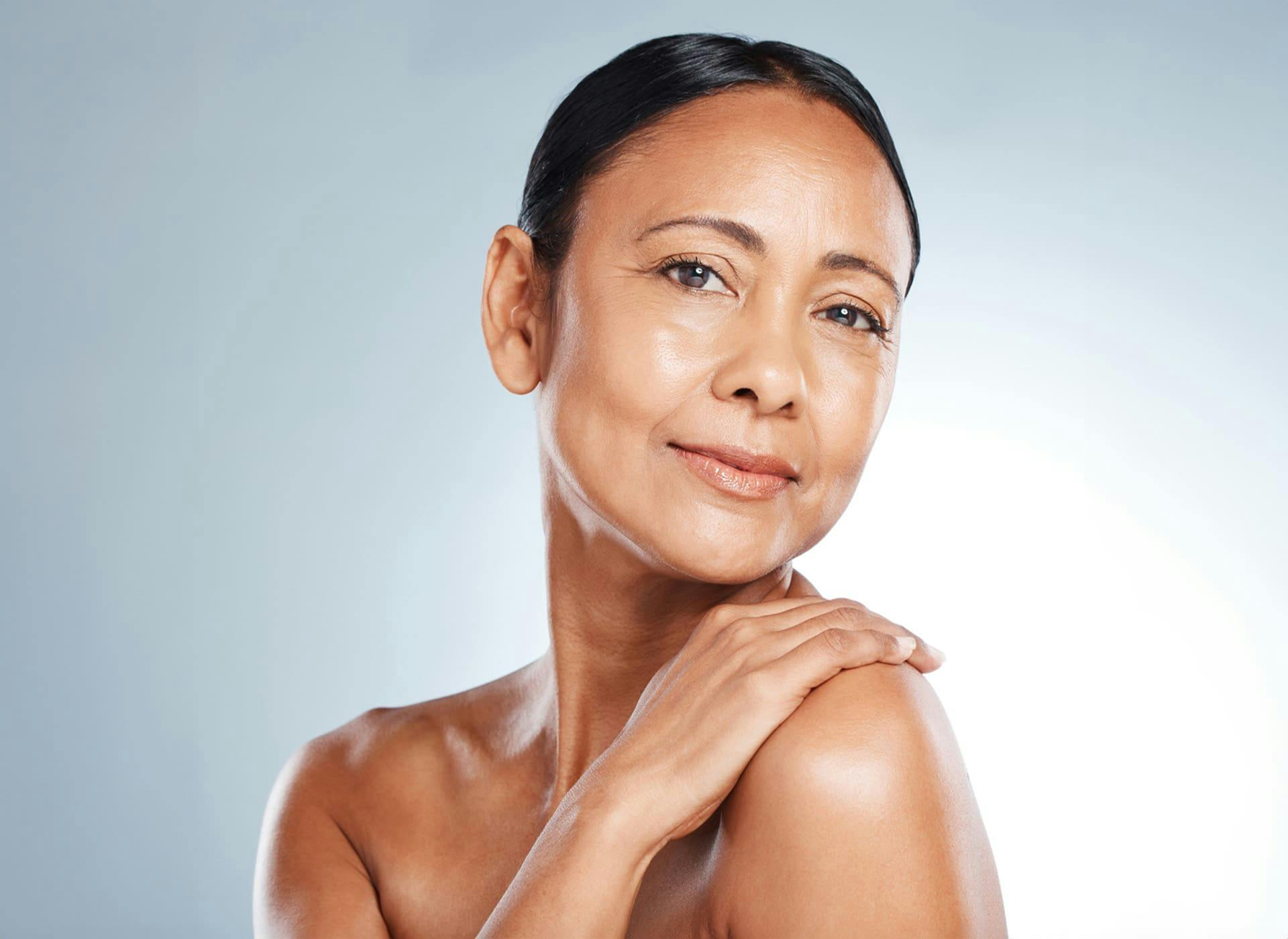 woman tilting her head with her hand on her shoulder
