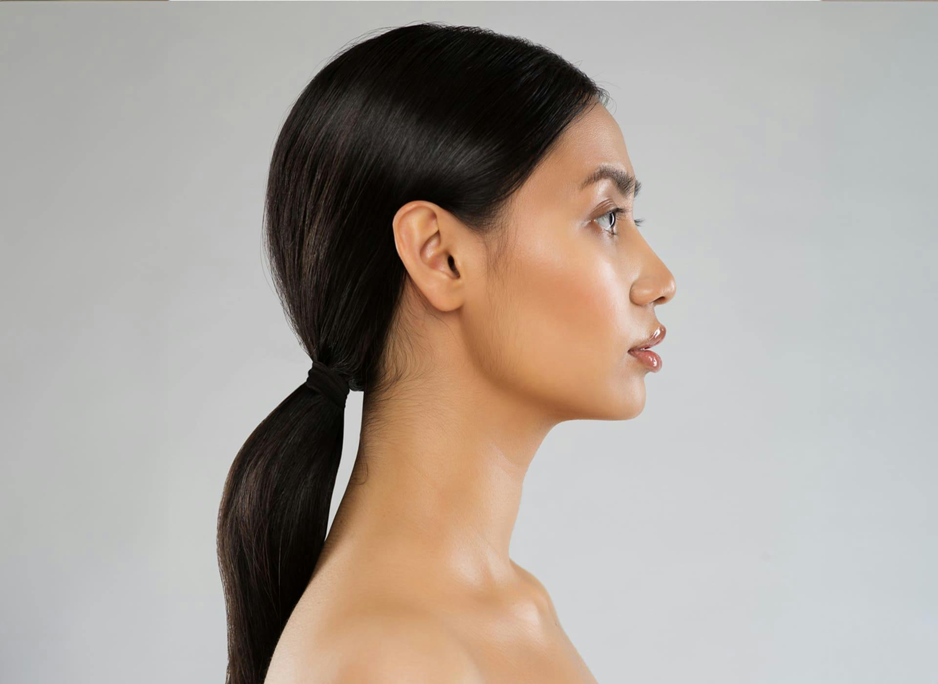 side profile of woman with low ponytail