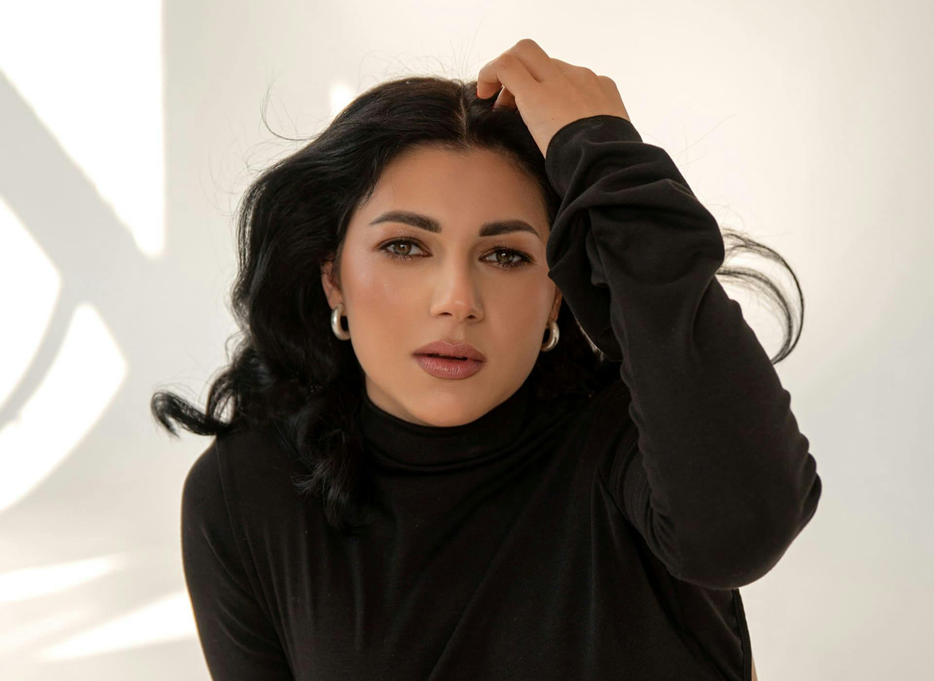 woman moving her hair back