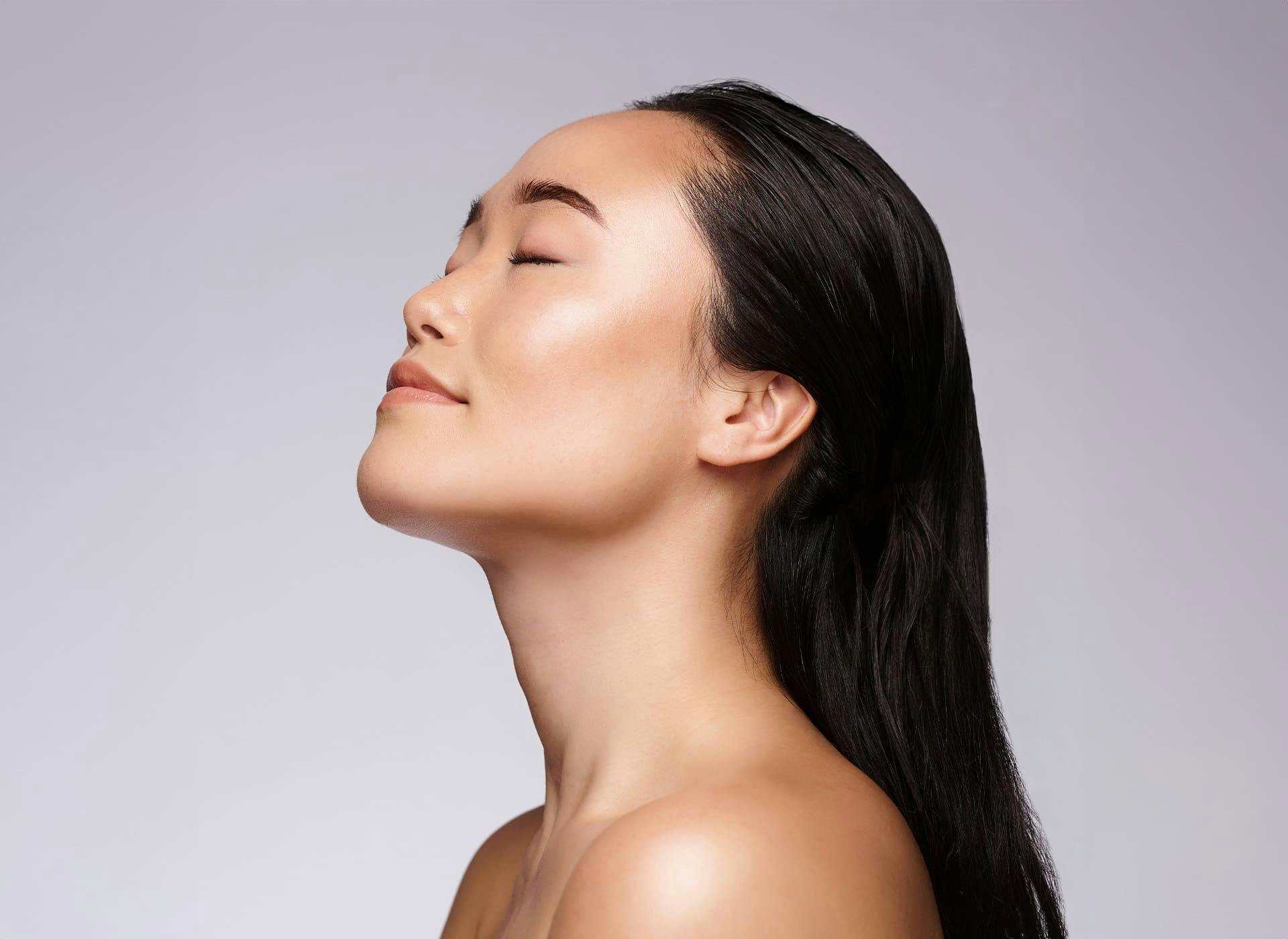 woman looking upward with her eyes closed