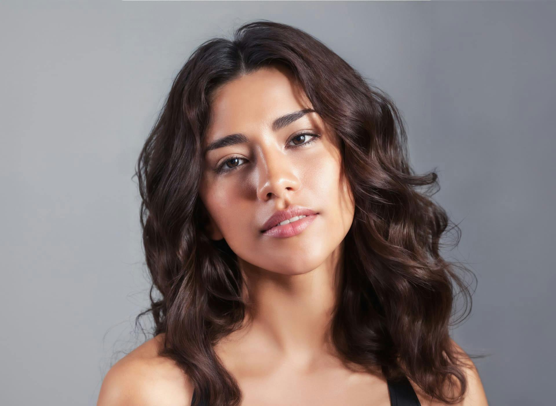 woman looking forward with wavy brunette hair