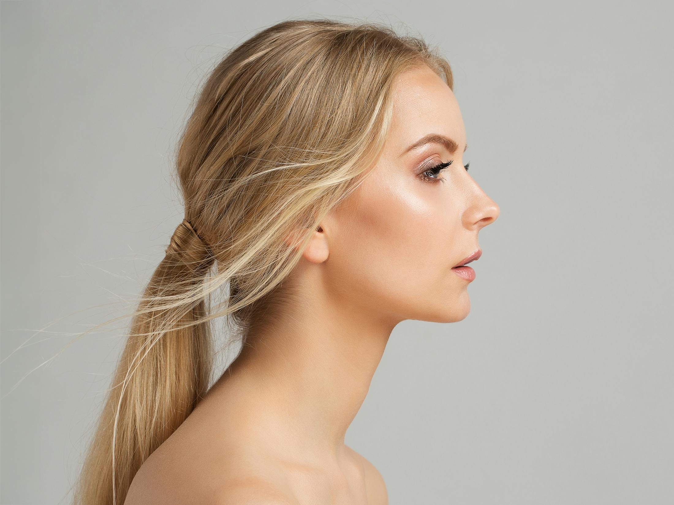 woman with blonde hair in a low ponytail