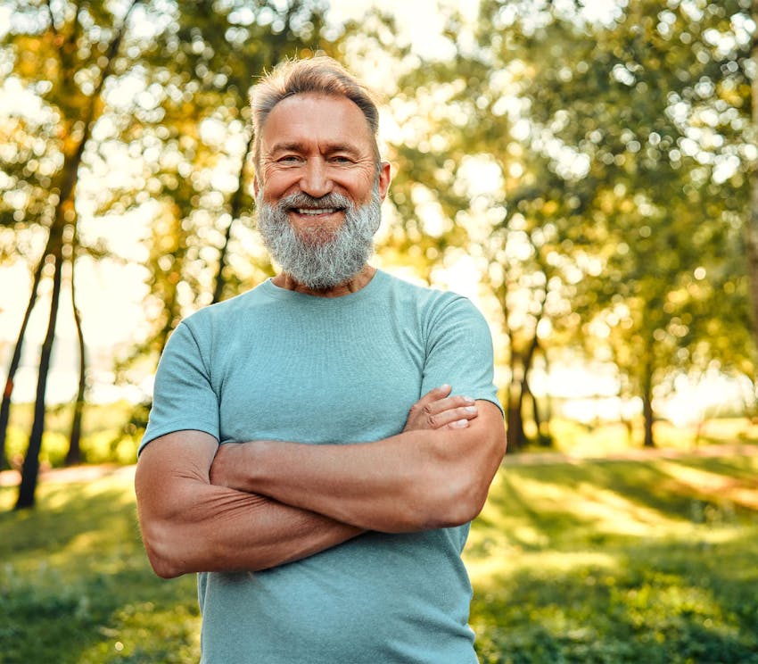 man smiling with his arms crossed