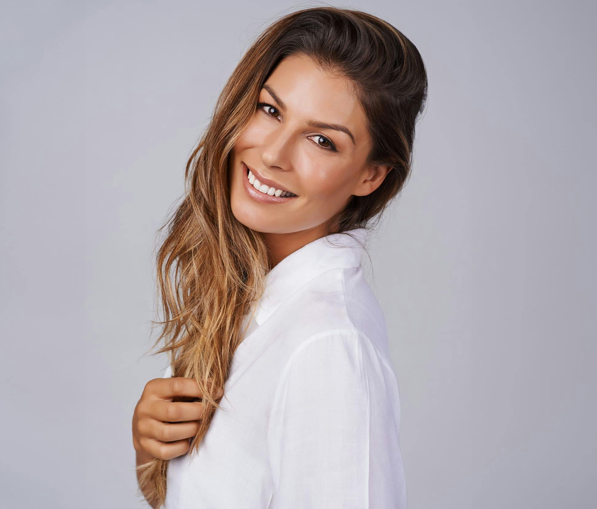 woman smiling with her head tilted back