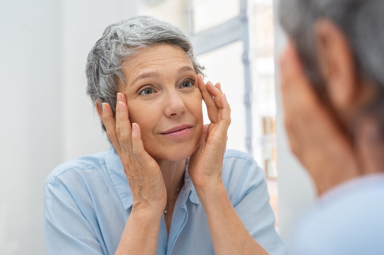Older woman looking in mirror
