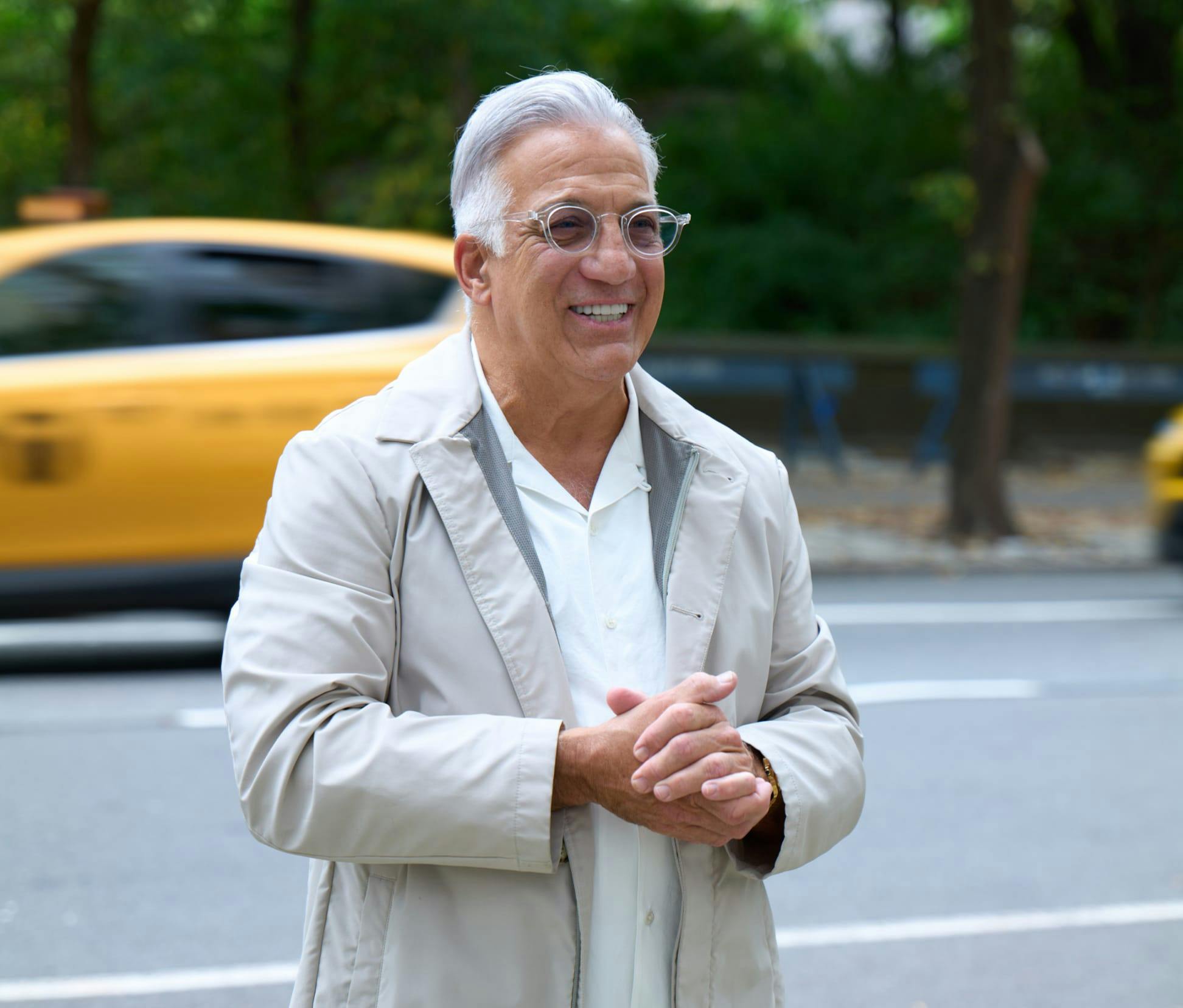 doctor with white jacket on with his hands together