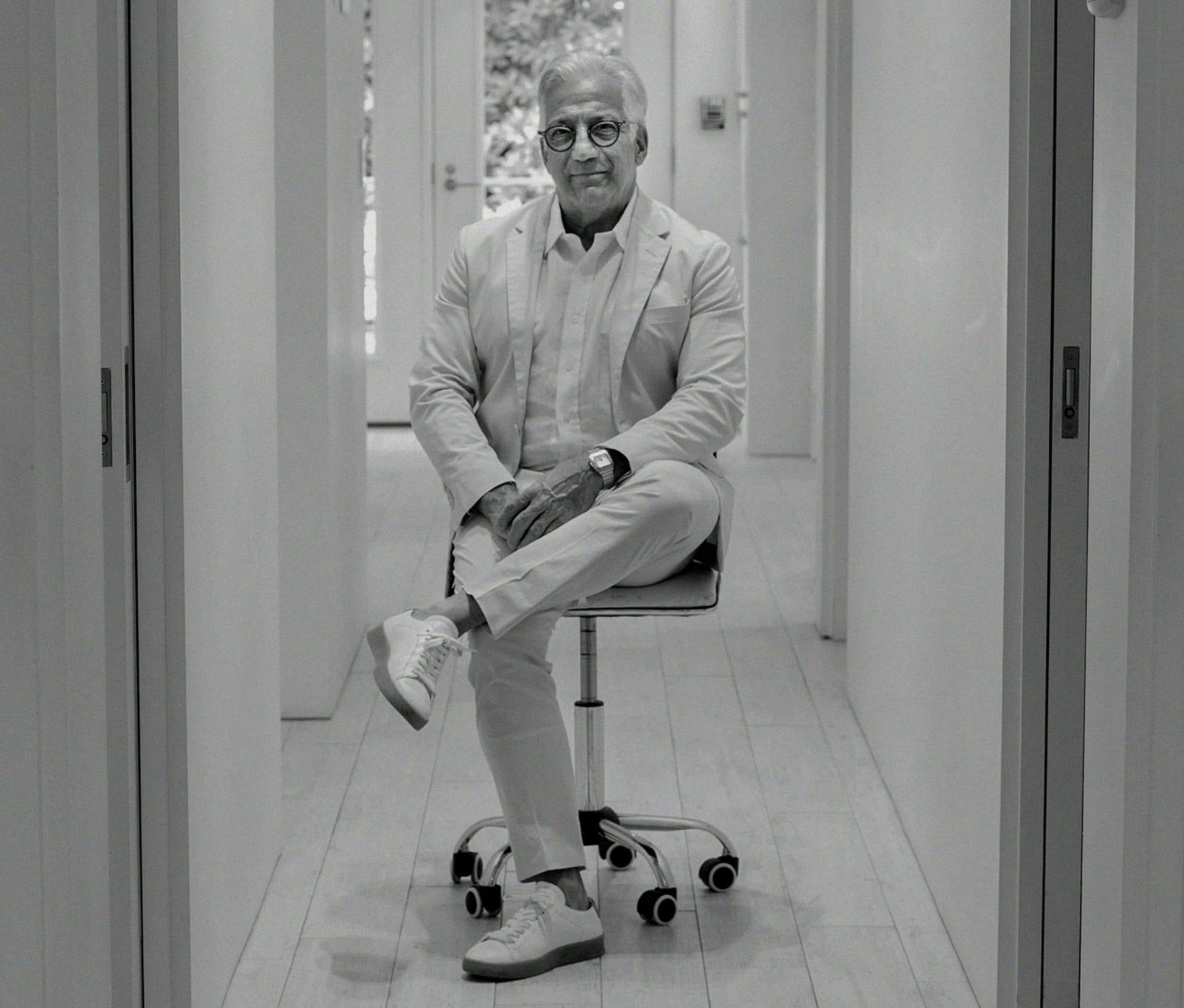 greyscale of Dr. Gerry sitting in a chair