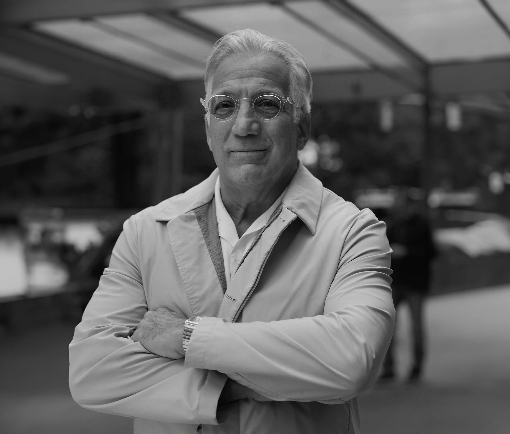 greyscale of Gerry Curatola crossing his arms in suit