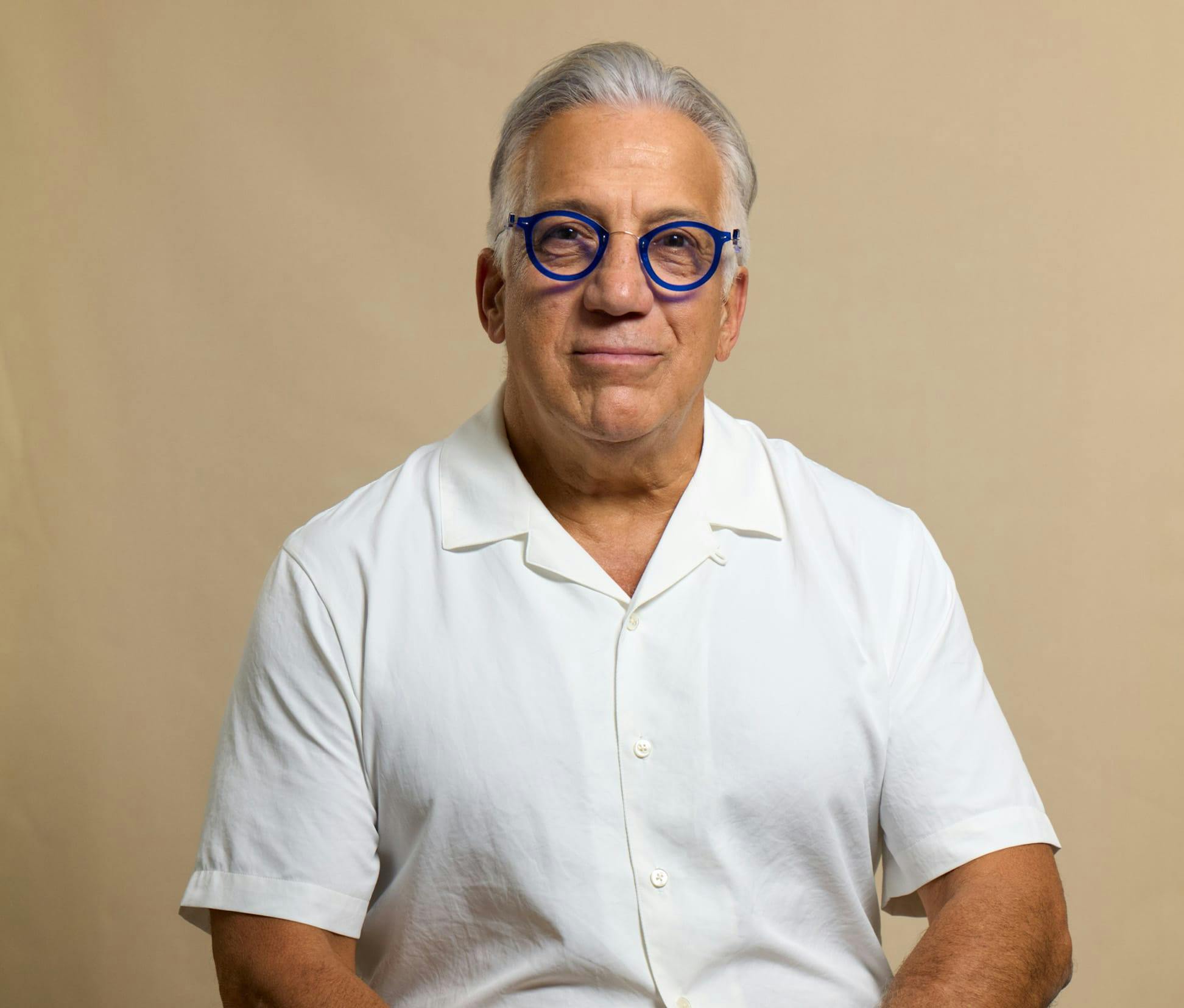 Gerry Curatola in white shirt sitting down