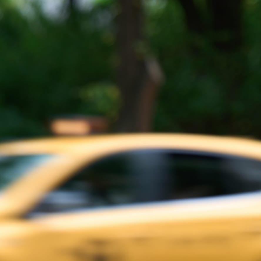 greyscale of blurred car passing
