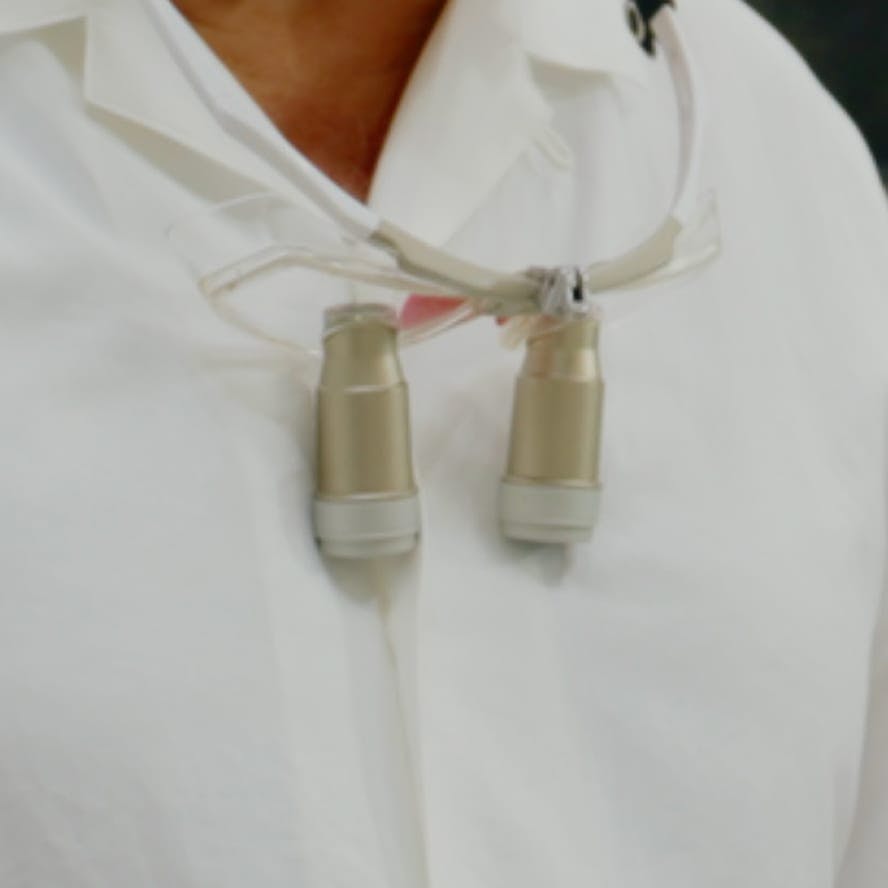 greyscale of doctor binoculars around neck