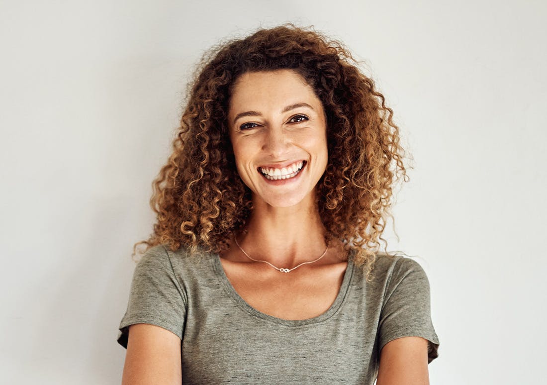 woman with curly hair smiling