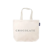 Natural canvas tote bag with the word “CHOCOLATE” printed in black across the front and long shoulder straps, shown on a transparent background.