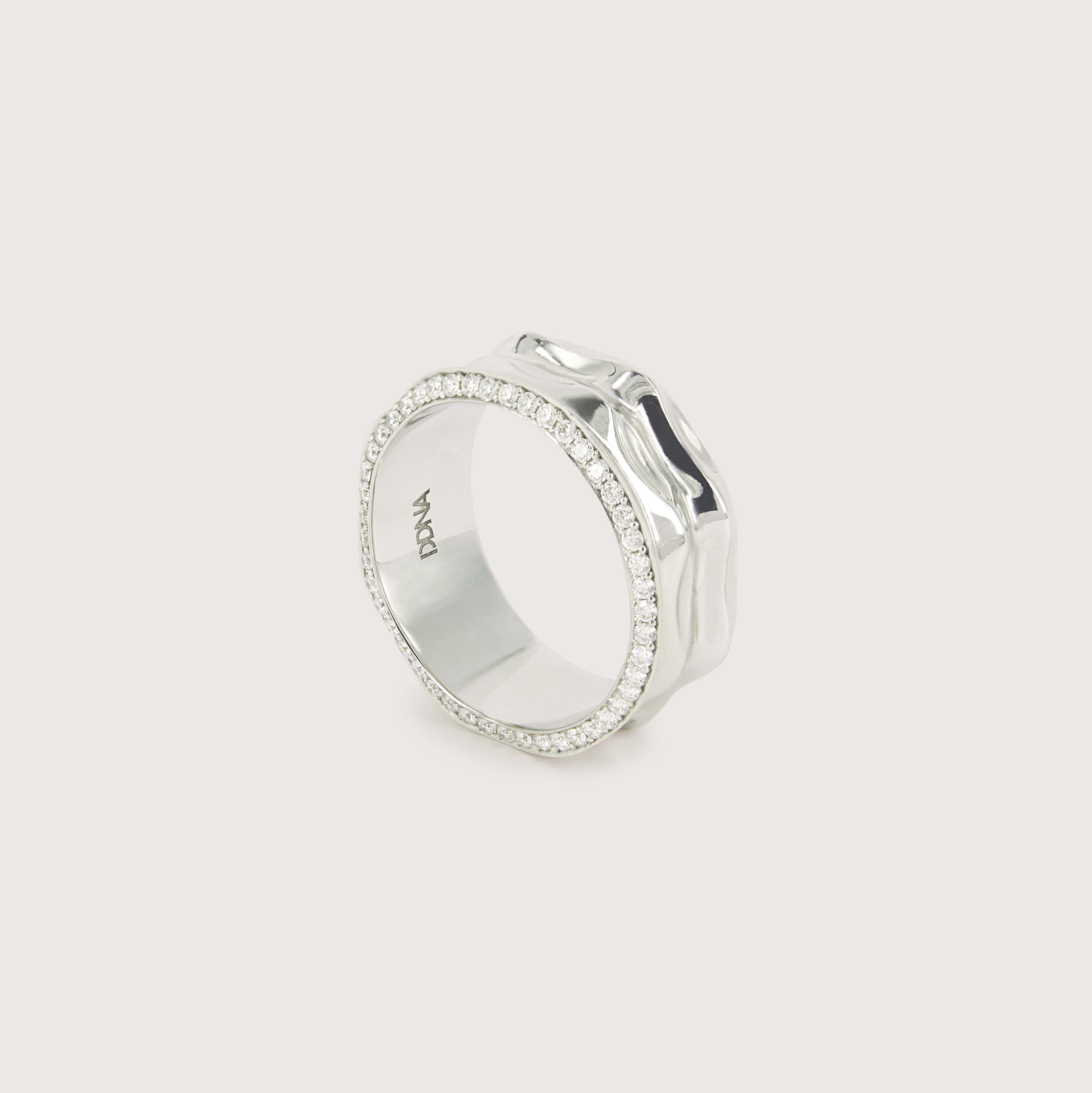 a white gold ring with a rippled surface design, featuring two sides of diamonds that frame the design.