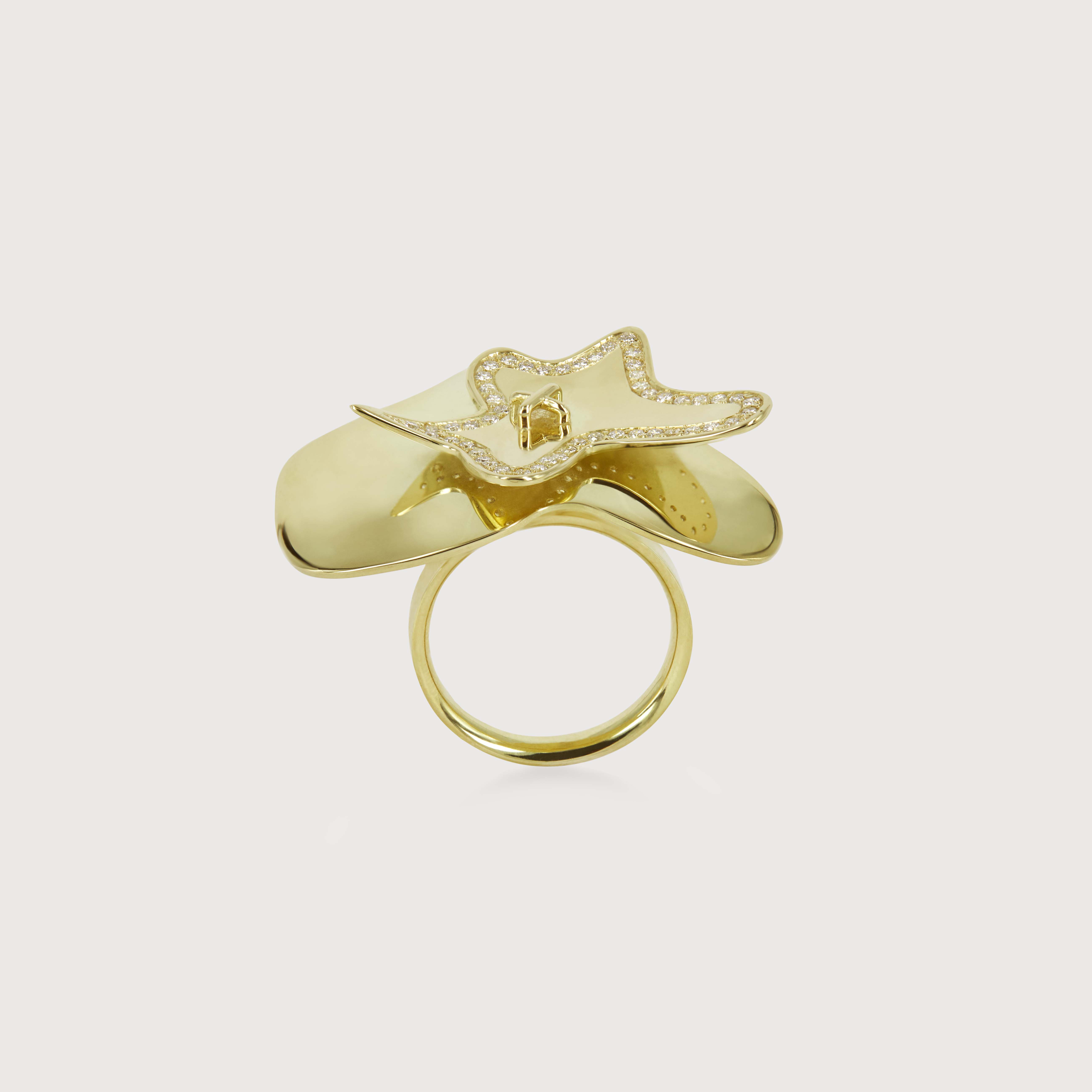 Yellow gold  ring with two uniquely shaped layers floating on top of each other. The top layer frames the shape with diamonds.