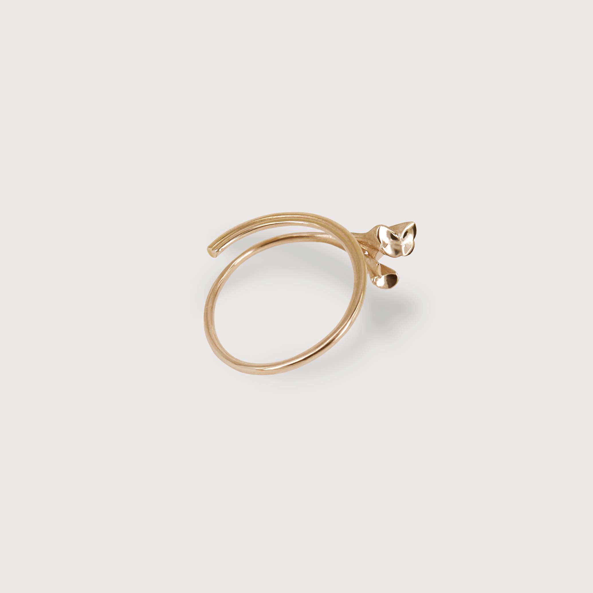 rose gold ring designed like a stem of a flower elegantly wrapping around