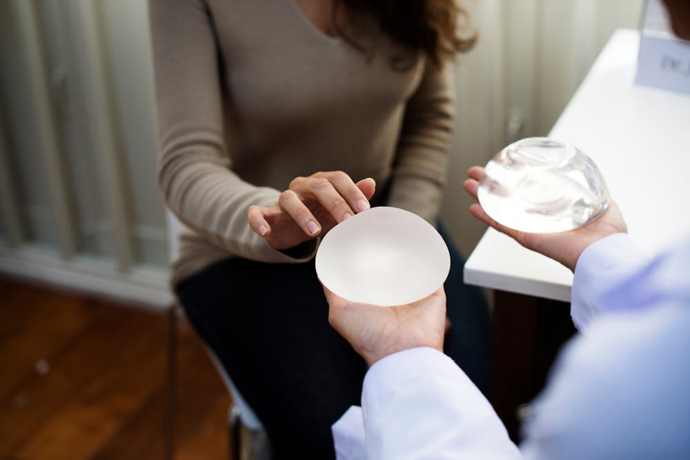 woman picking breast implant