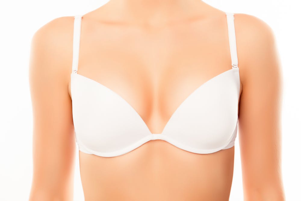 Close up of woman chest in white bra