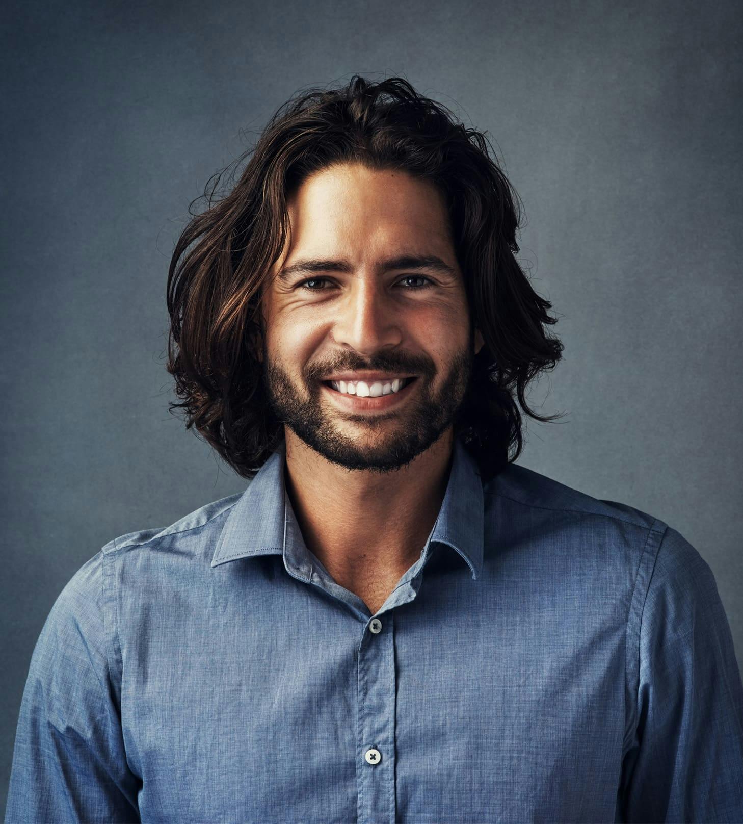 man smiling with medium-length hair