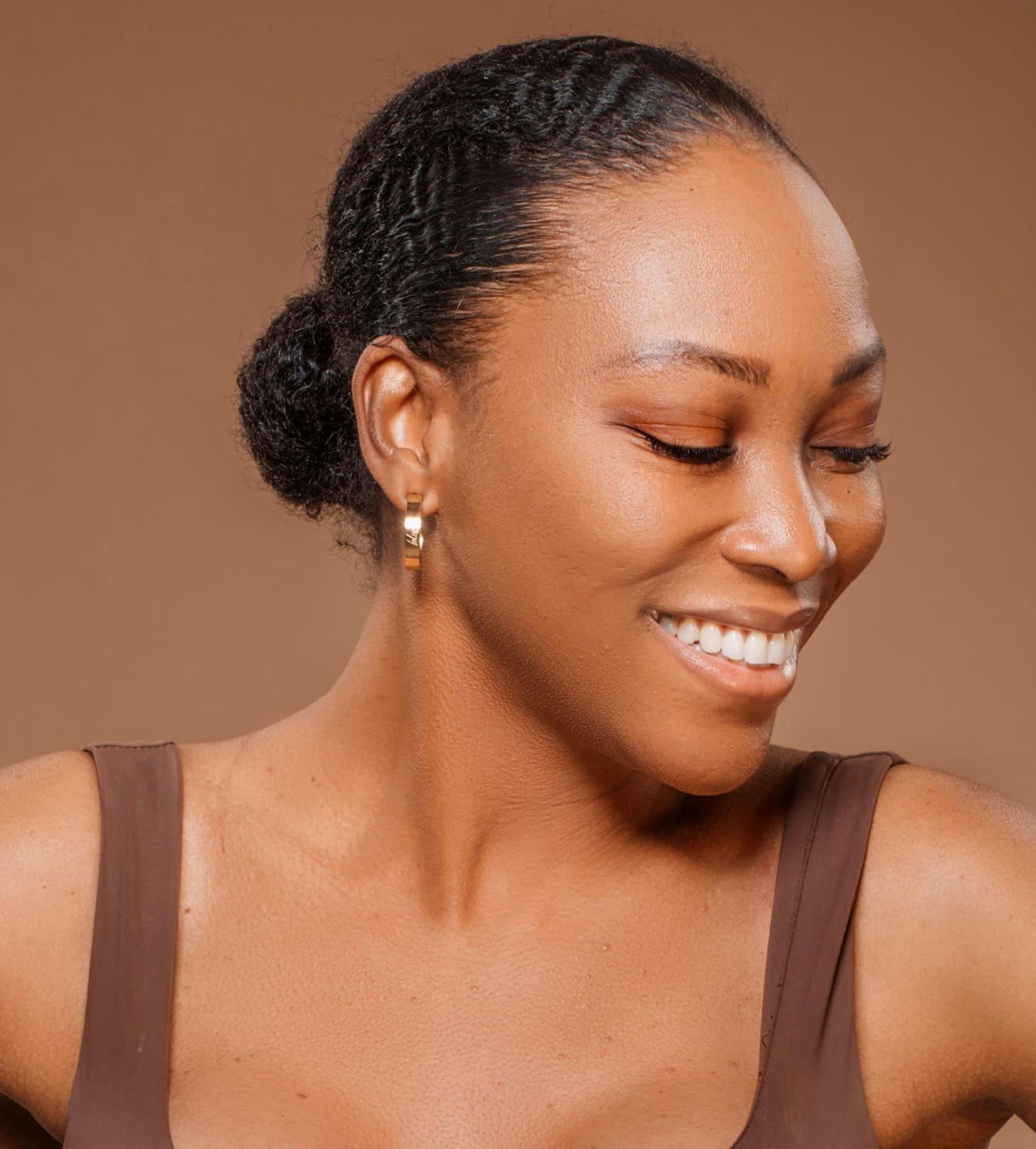 woman smiling with her hair in a low bun