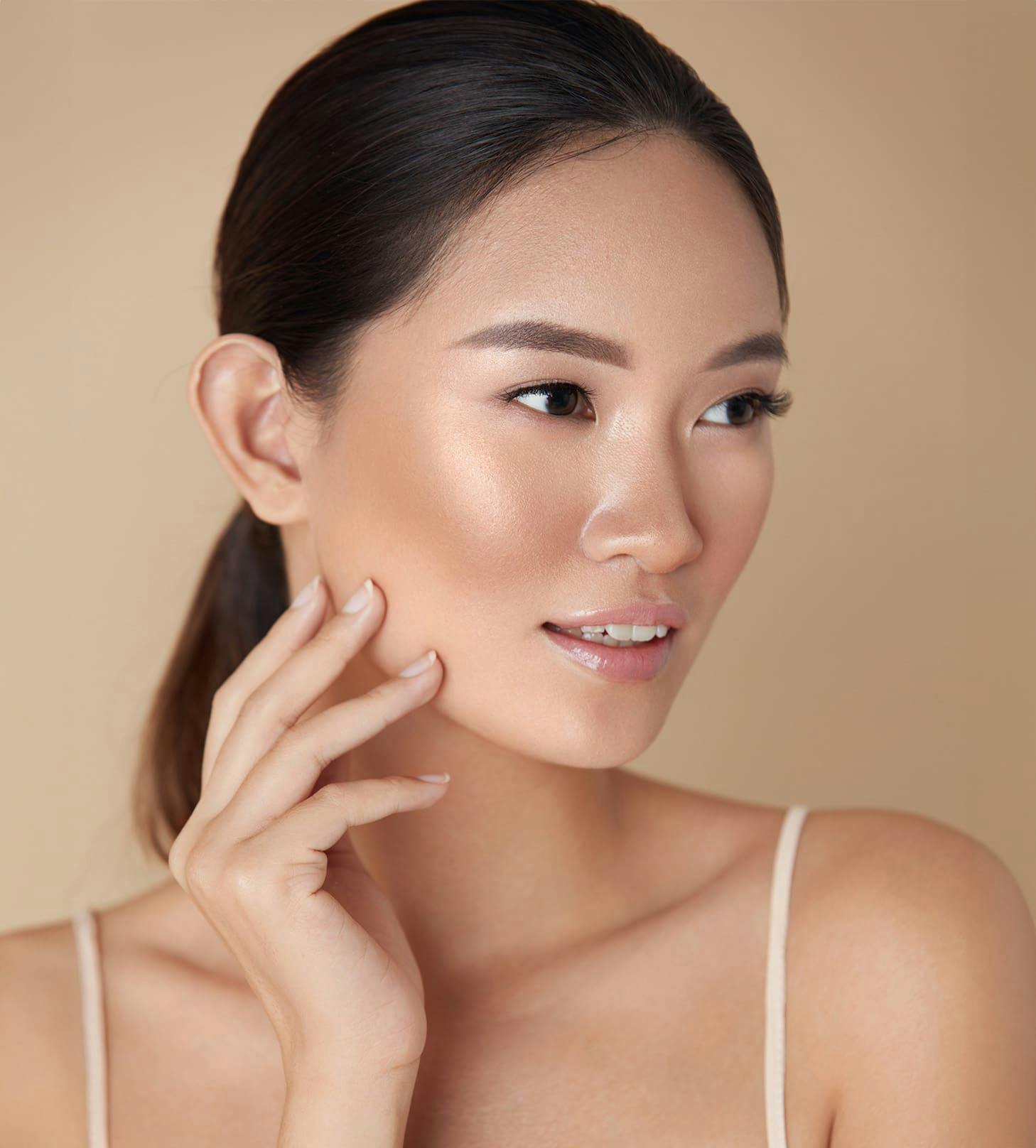 woman touching her face while looking to the right