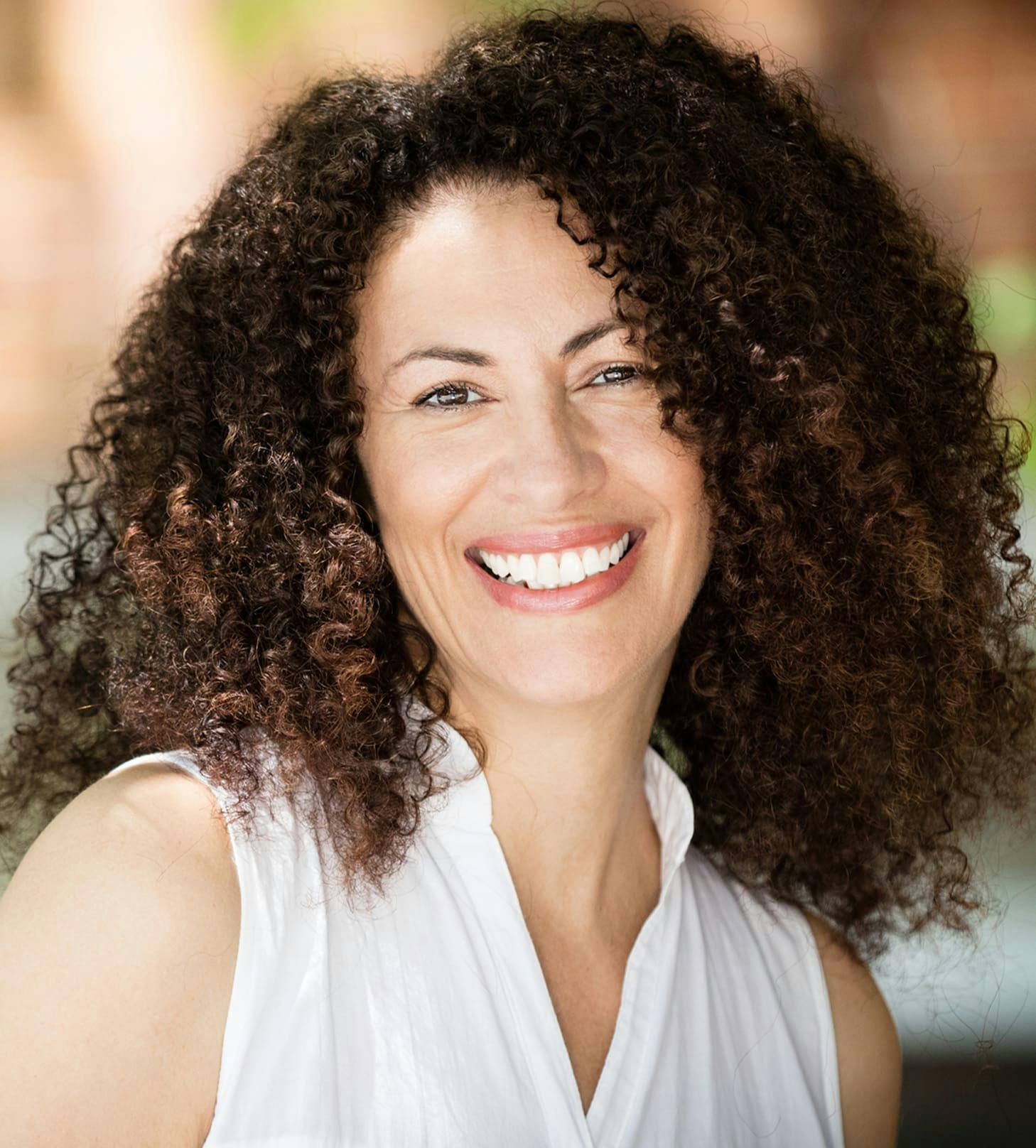 woman with curly afro smiling