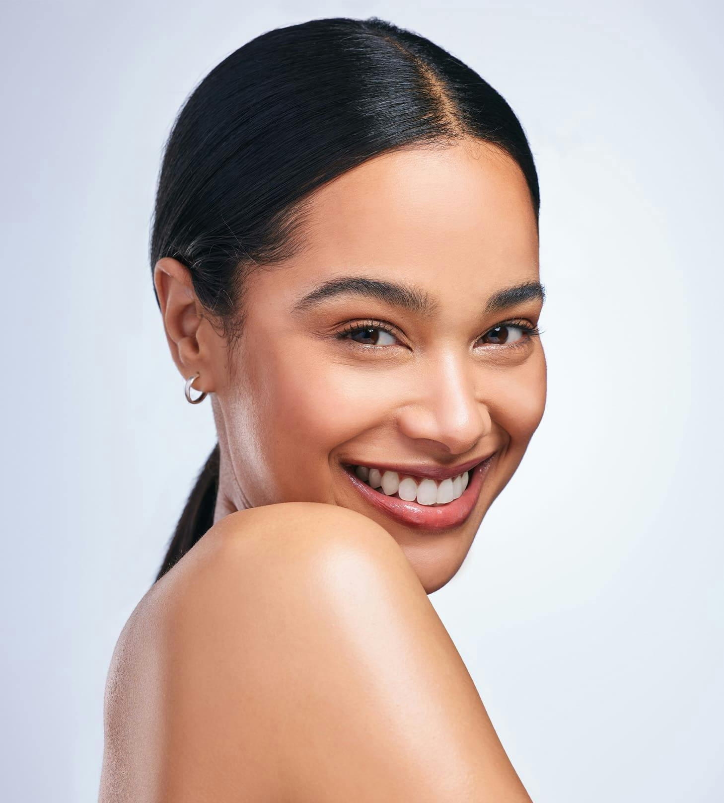 woman with low ponytail smiling