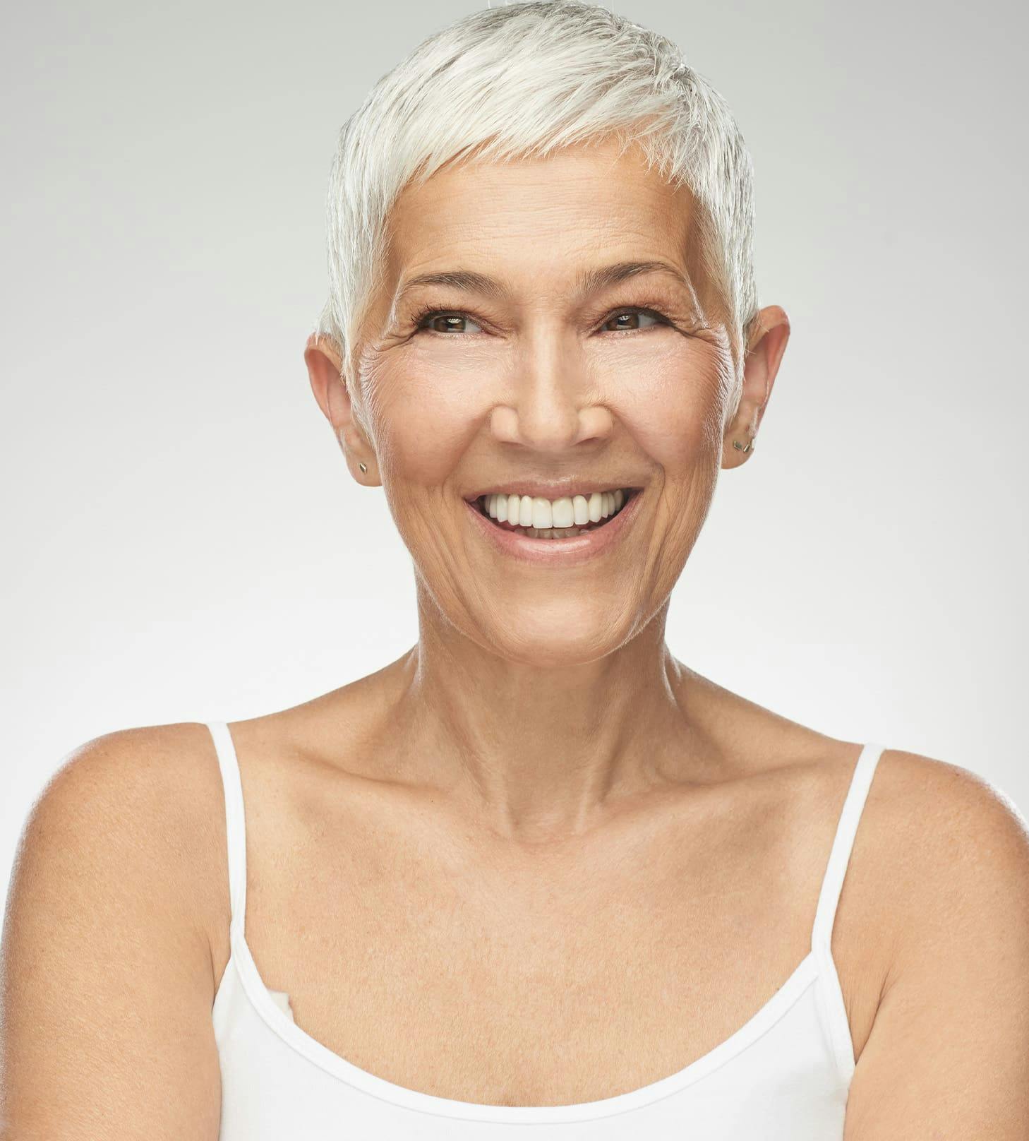 woman with short white hair in white tanktop