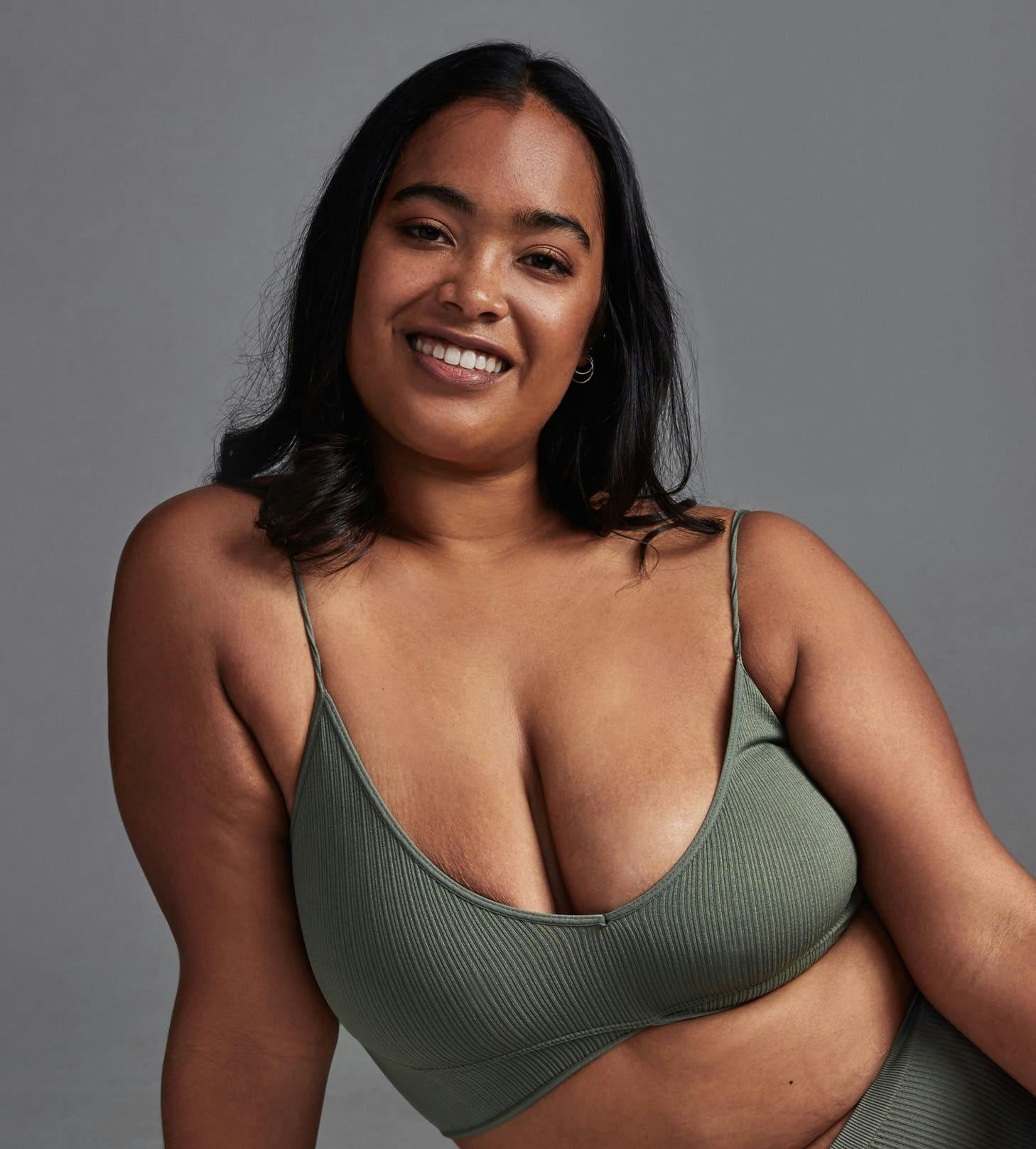 woman smiling in green underwear set