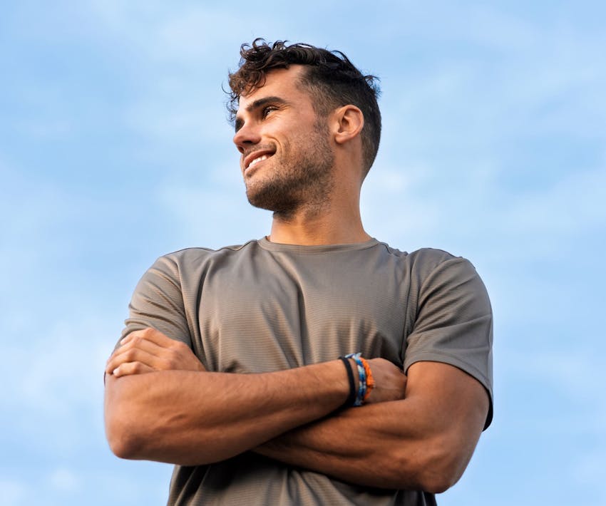man looking to the left with his arms crossed