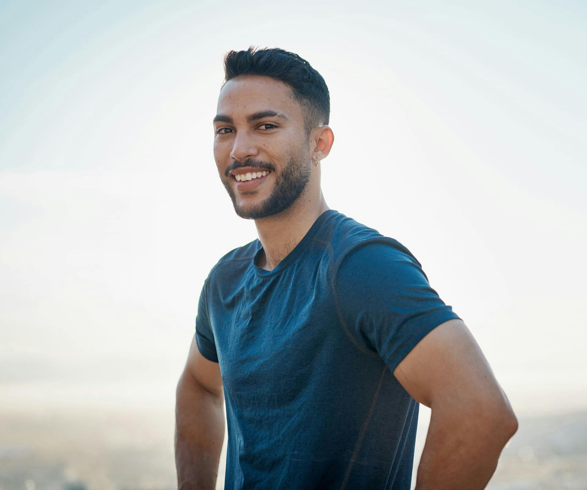 man smiling in a blue shirt