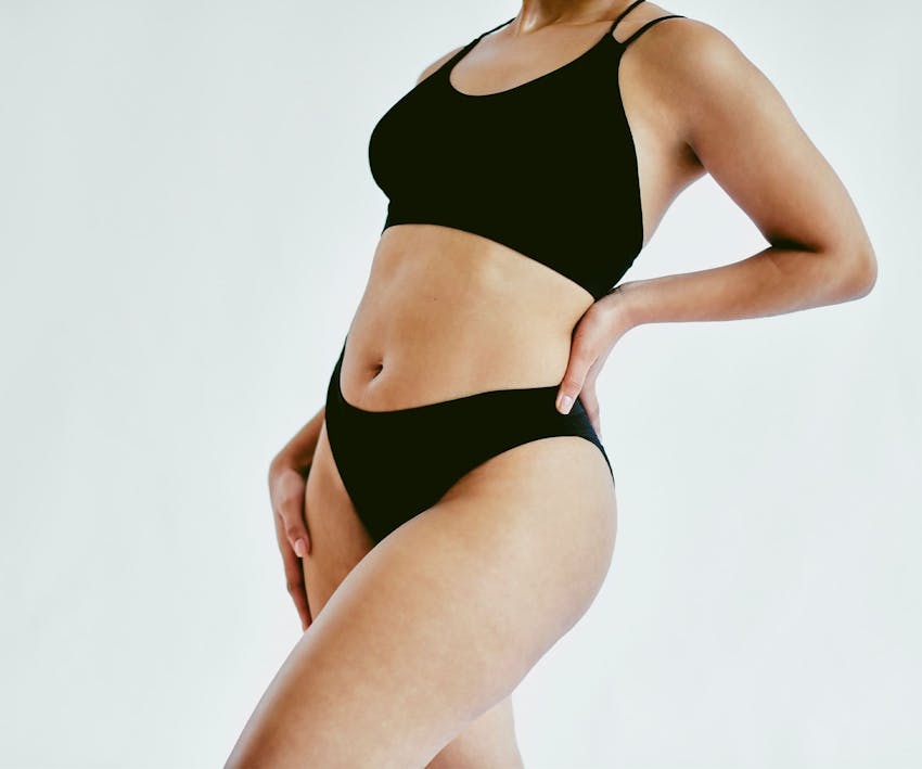 woman's body leaning back slightly in black underwear set
