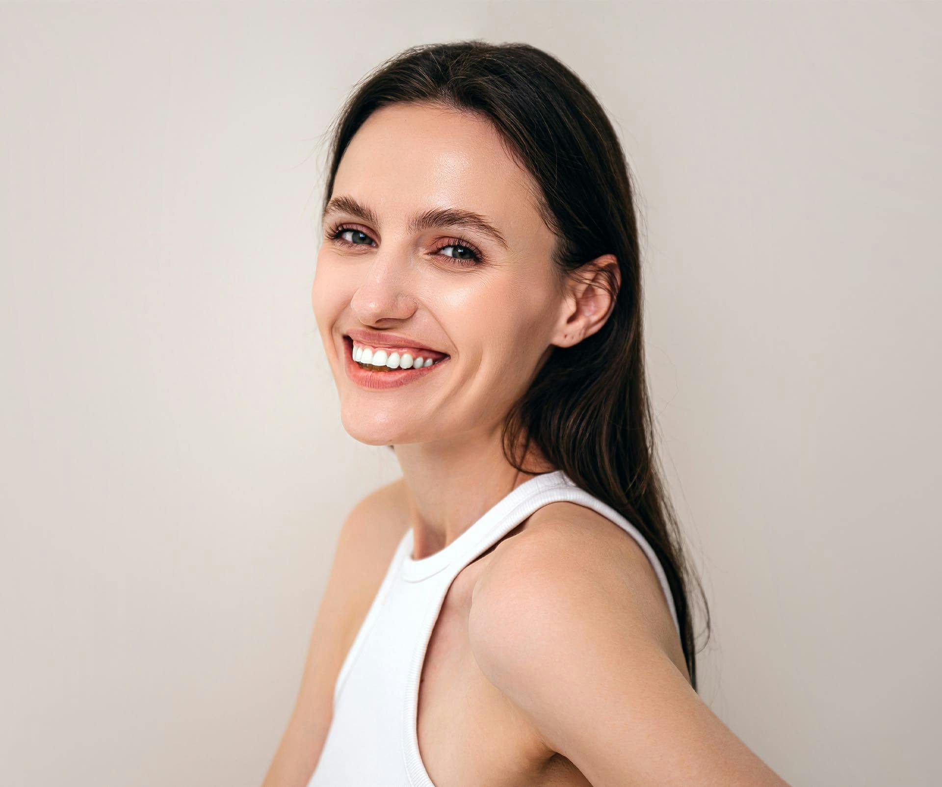 woman smiling with straight brunette hair