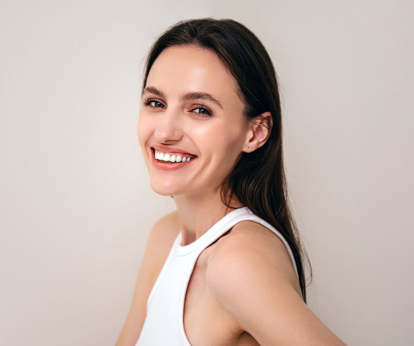 woman smiling with straight brunette hair