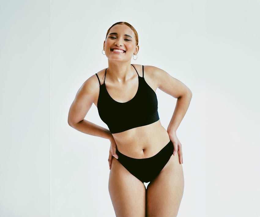 woman smiling with her hands on her hips