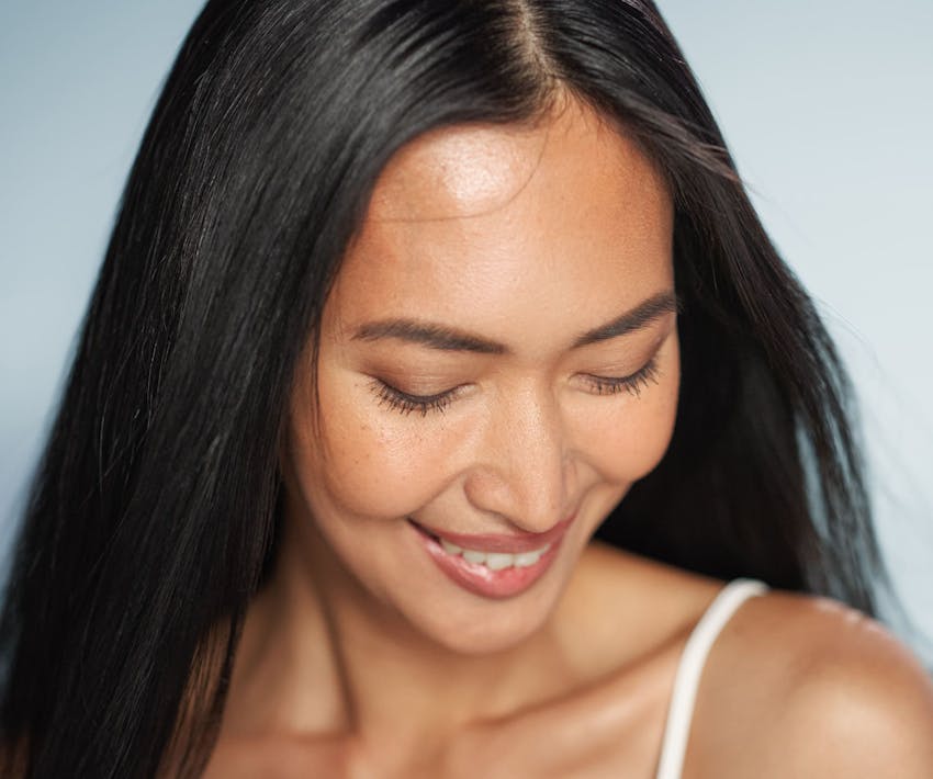 woman smiling and looking down