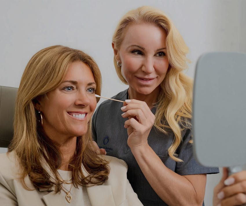 woman looking at mirror and smiling