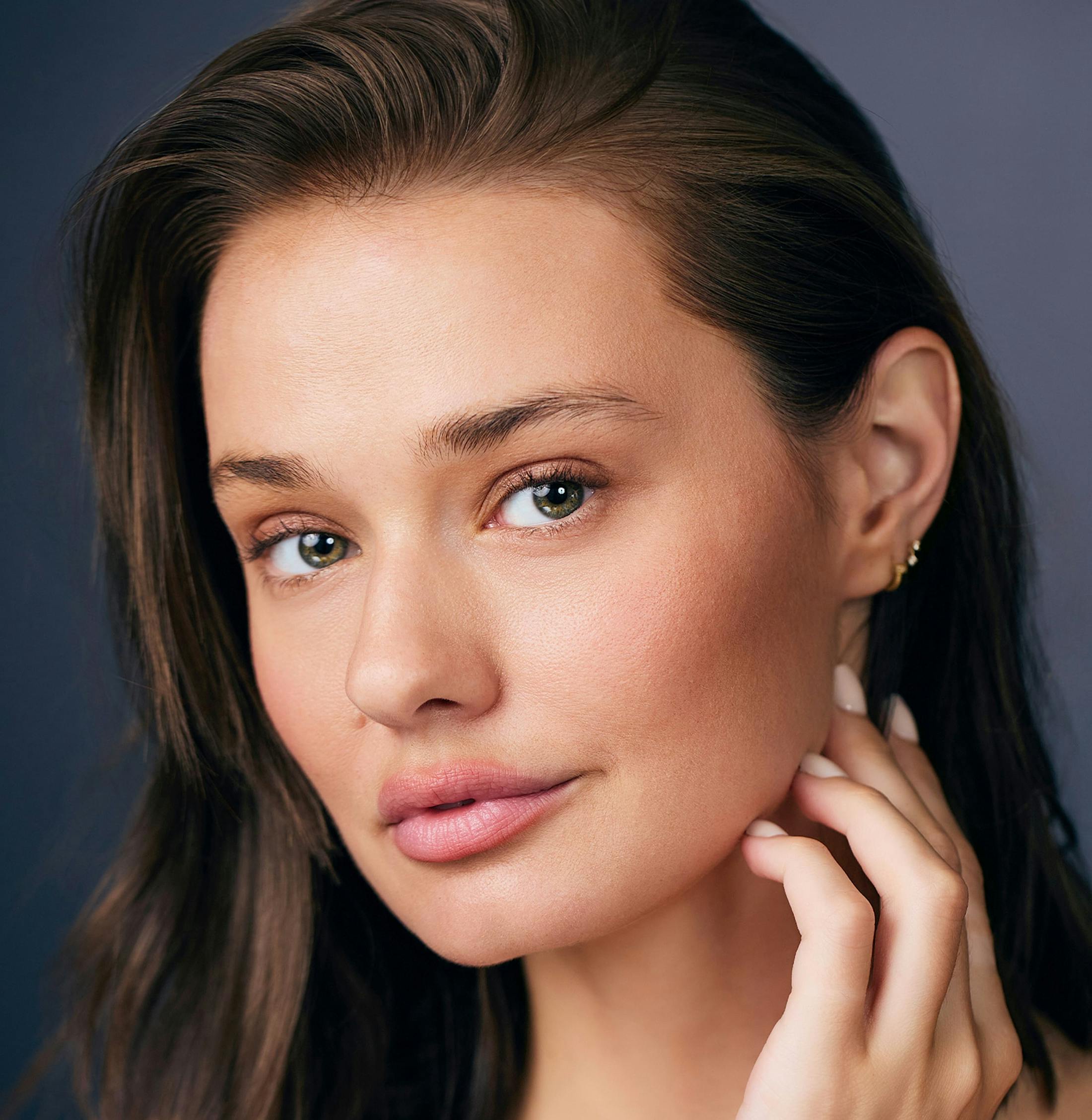 Woman touching her jawline