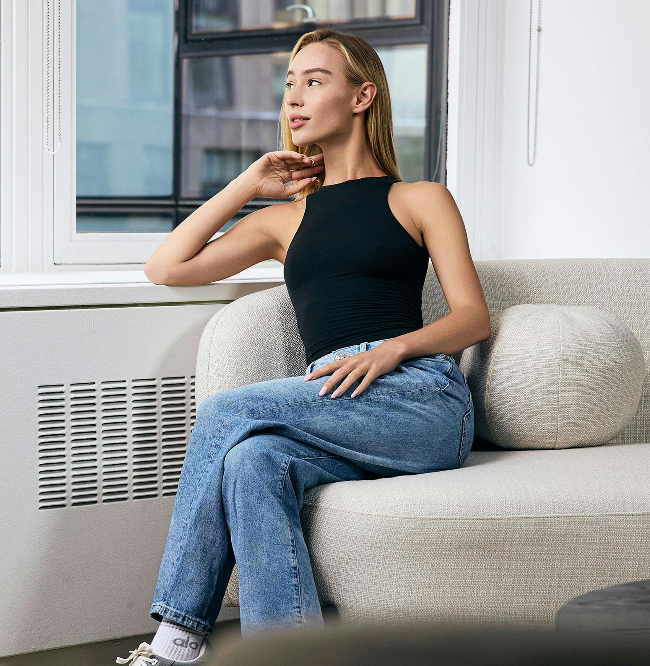 Woman sitting on the couch smiling