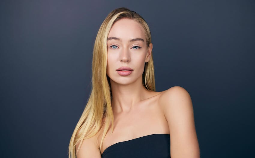 Woman standing against deep blue background