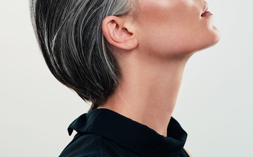 close up of woman's neck with her head tilted back