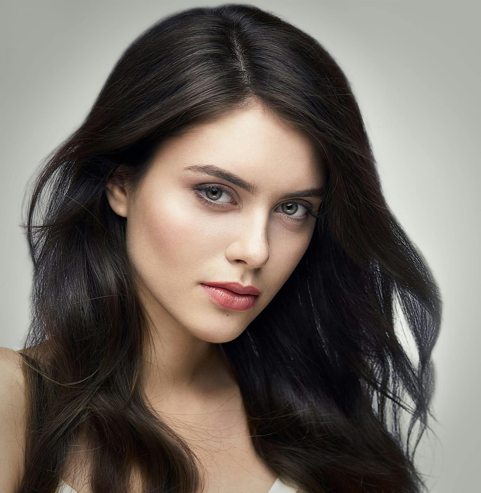 long dark haired woman looking forward