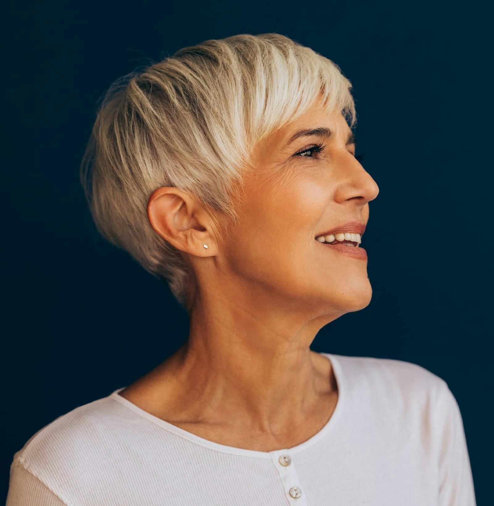 side profile of woman with short hair in white shirt