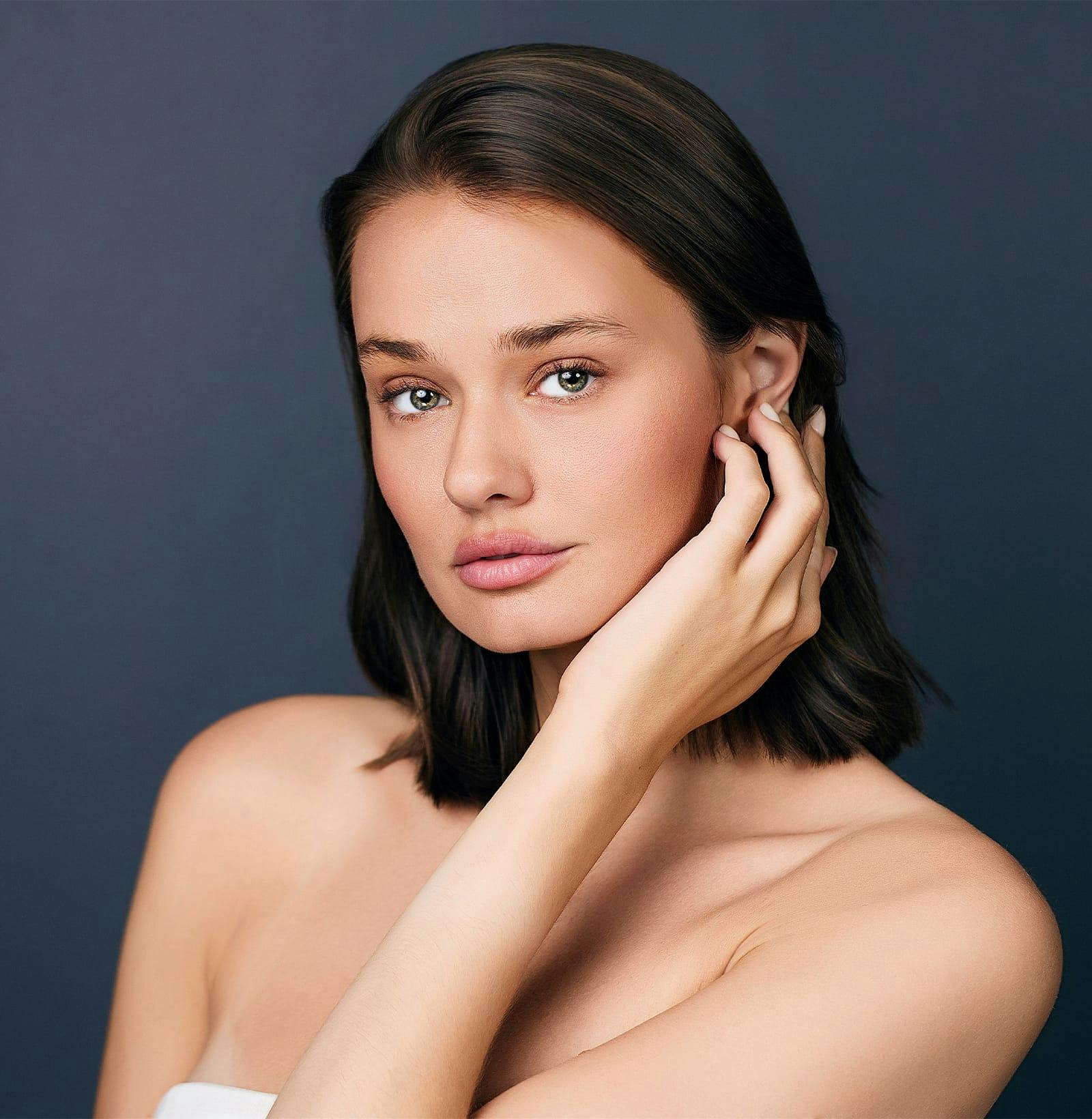 woman tucking her hair behind her ear