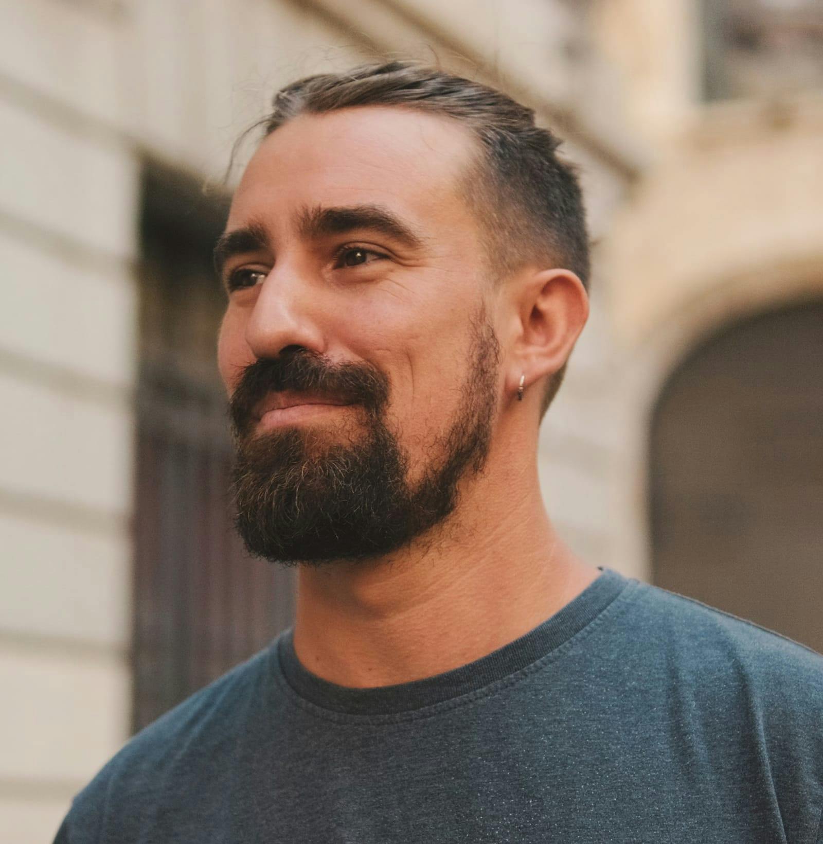 close up of man's face wearing a blue t-shirt