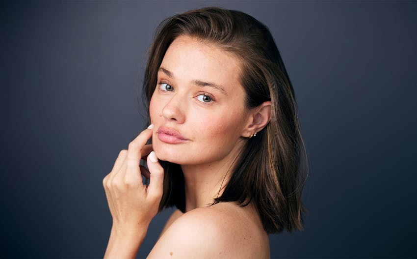 close up of woman's face with her hair in a bun