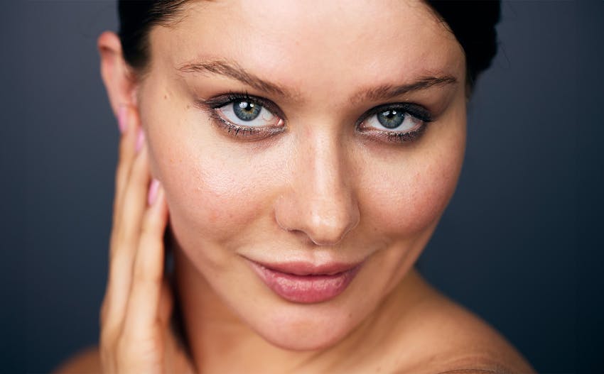 woman with hands resting on the side of her face